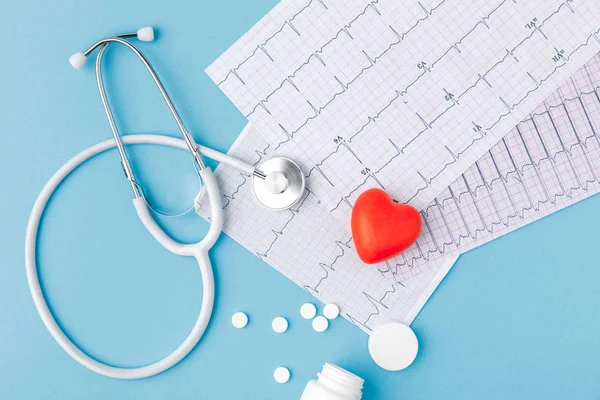 depositphotos 178964966 stock photo stethoscope paper cardiogram scattered pills