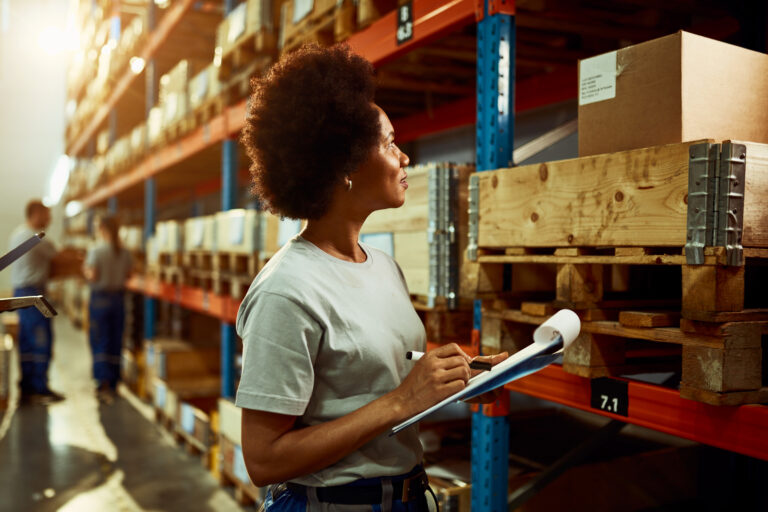 african american worker writing inventory list while checking stock storage room 768x512